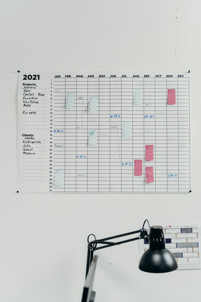 Home A 2021 wall calendar in a simple office setting for planning and scheduling.